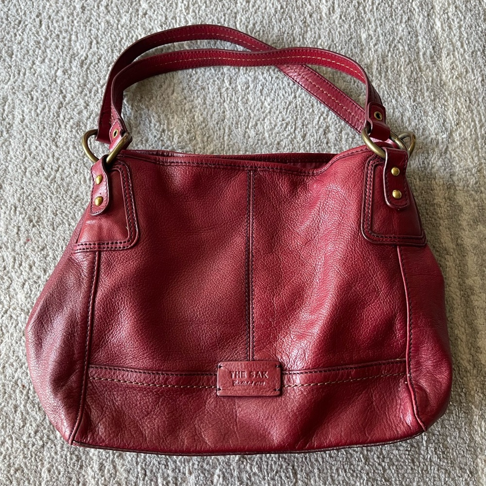 The Sak red leather purse in good condition